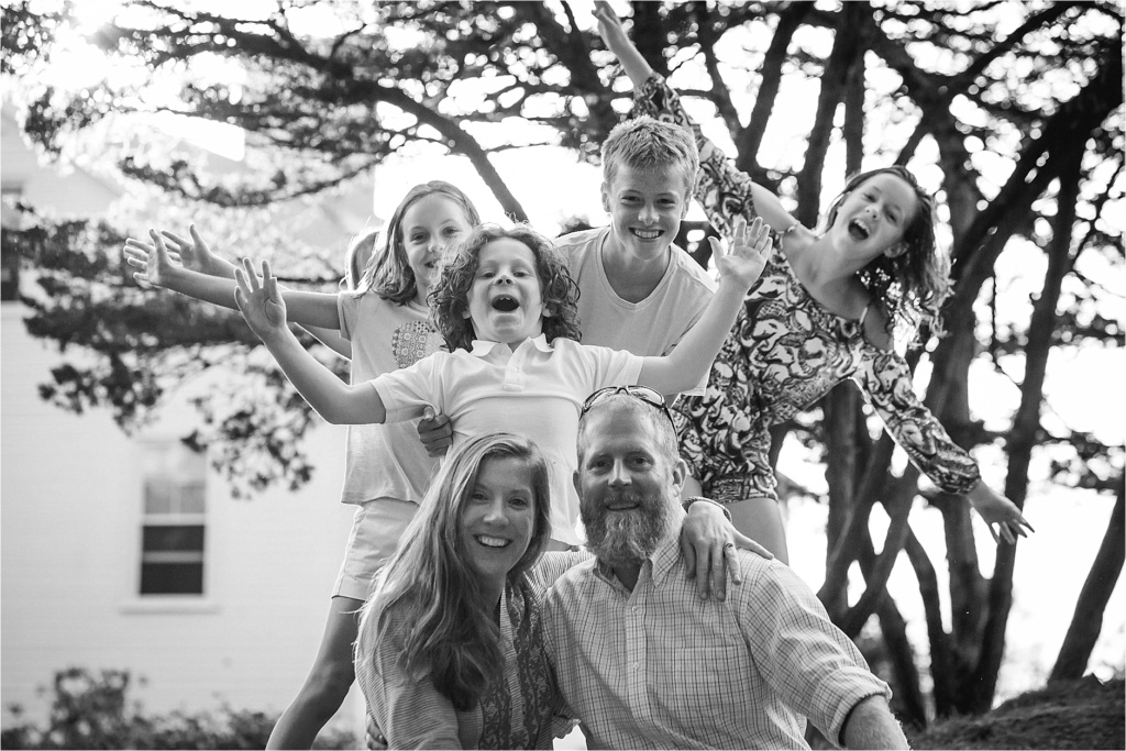 Couple's Portrait with kids sneaking up behind them photobomb Kennebunkport Maine Sarah Jane Photography