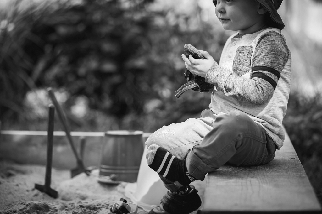 Little boy in a sandbox during portrait session Portland Maine