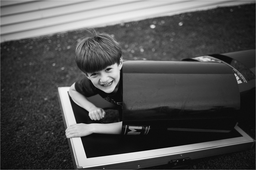 hiding in a tube black and white portrait of boy hiding in a tube York Maine Long Sands Beach
