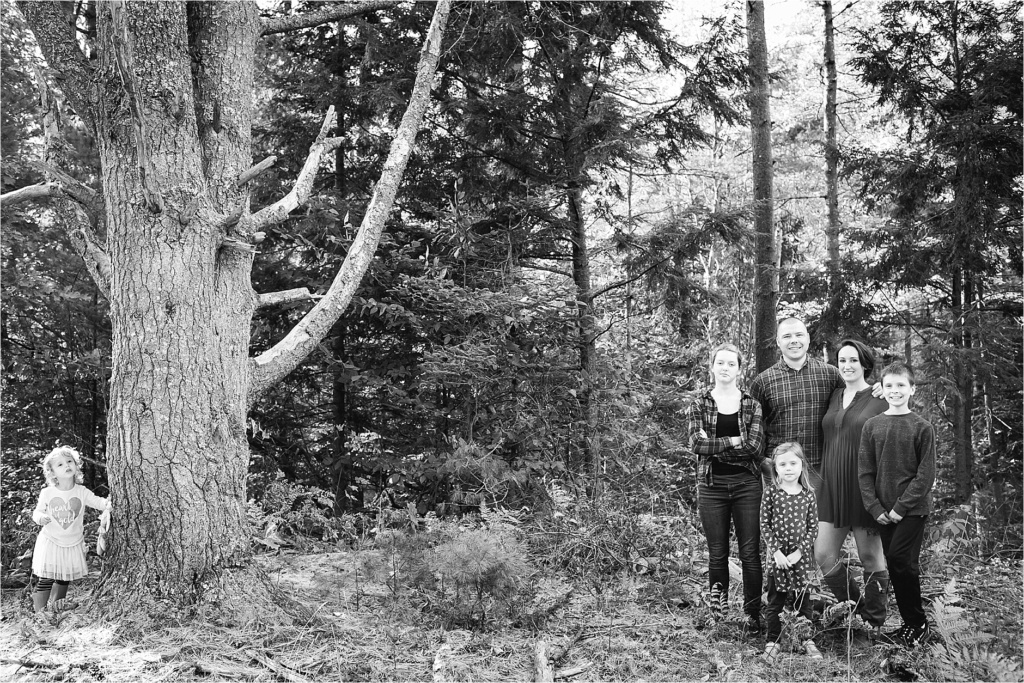 Toddler hiding behind a tree during Portrait session Sarah Jane Photography