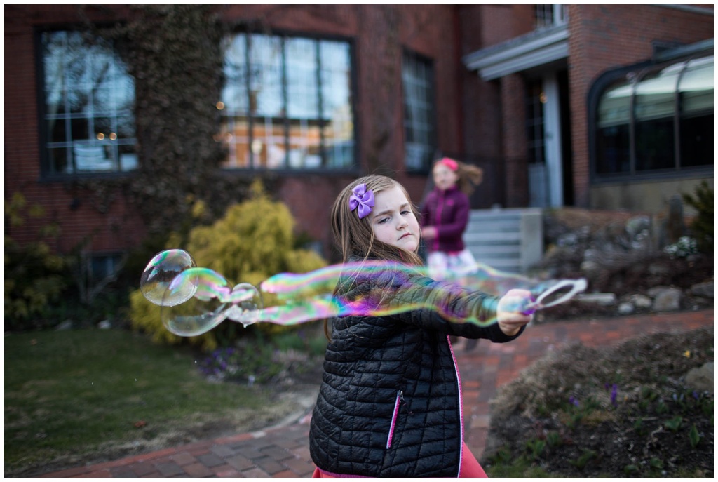 children playing with bubbles outside