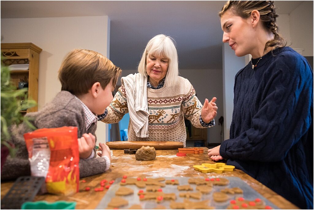 grandchildren making gingerbread cookies with grandma in Maine