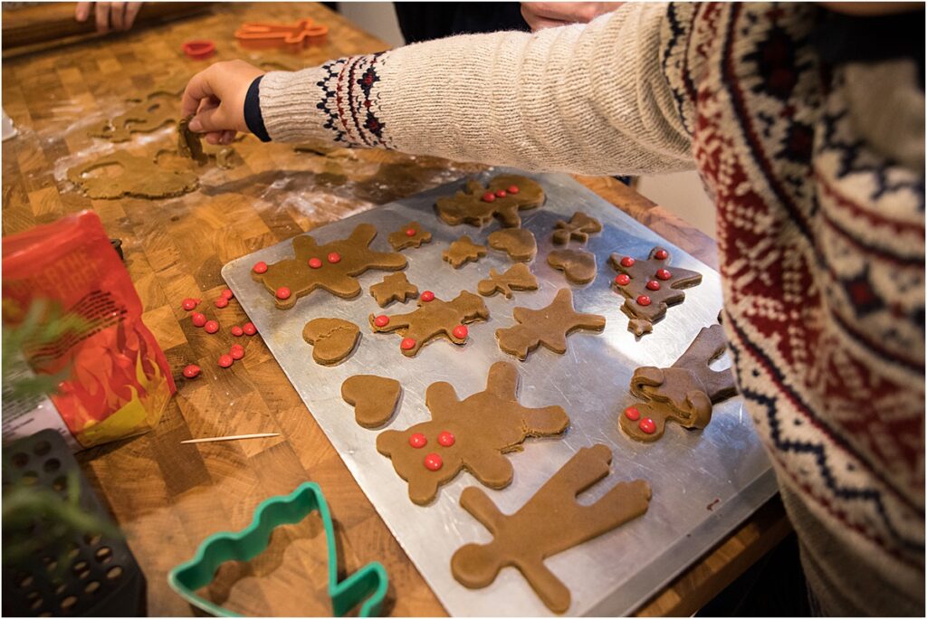 Family gathering with grandkids making gingerbread cookies with grandma as part of their holiday traditions